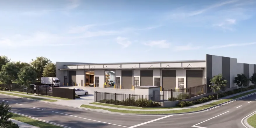 Corner-site industrial development with a delivery truck at an open roller door and precast panel walls.
