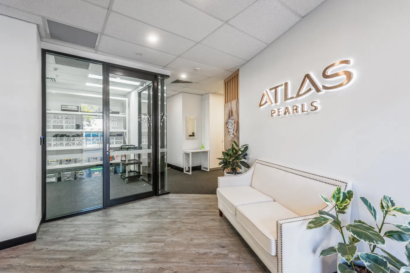 Atlas Pearls — Glazed office fronts along the main circulation spine.