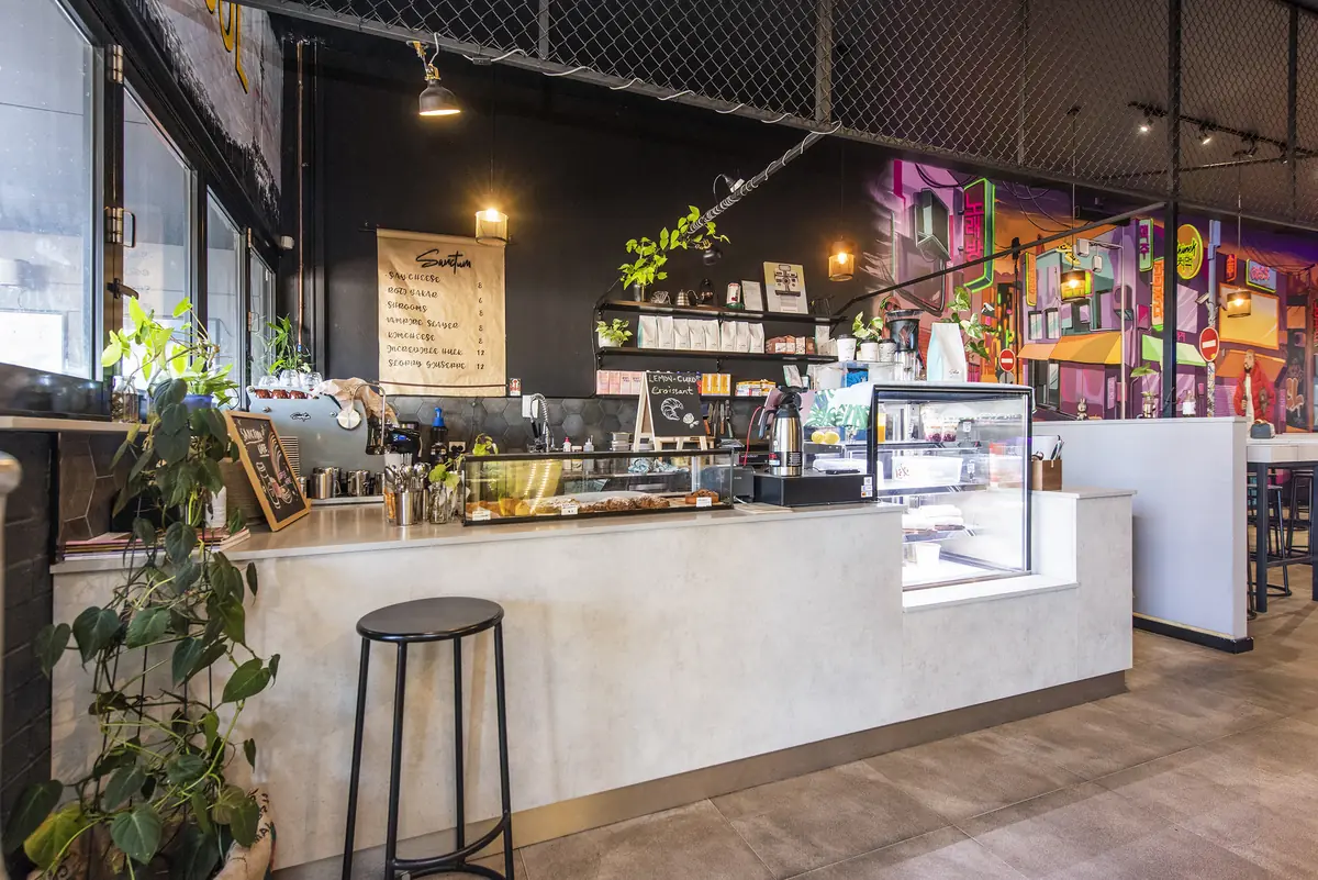 Sanctum Cafe &mdash; counter and pass with menu boards and feature lighting