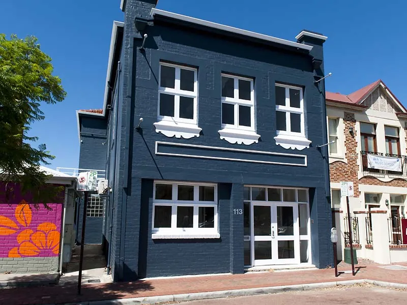JDL Strategies — Restored two-storey heritage facade in dark blue.