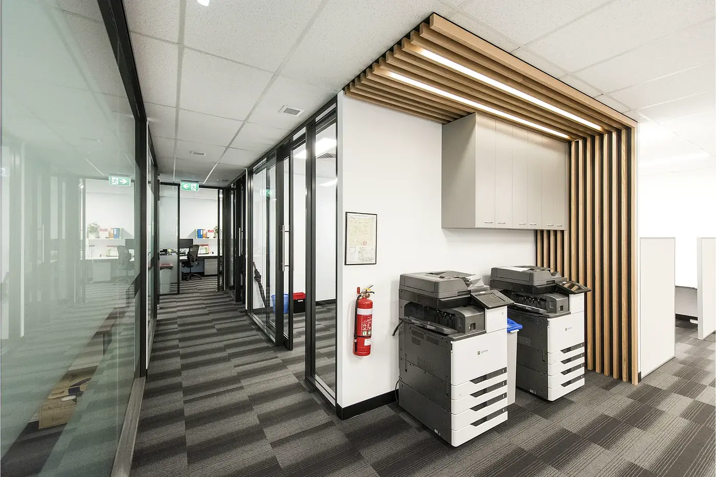 VEOLIA &mdash; print and joinery zone set into a timber batten portal off the main corridor.